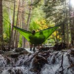 two person on green mesh hammock outdoor